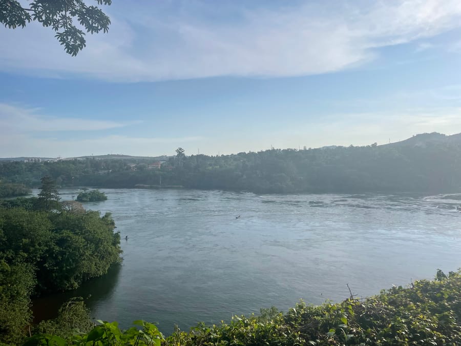 A calm reach at morning, a boat mid-river